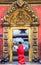 Nepalese woman walking by the Golden Gate in Bhaktapur