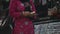 A nepalese woman wearing traditional clothes using, holding, selling a mortar and a pestle in Kathmandu. A close up view