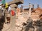 Nepalese worker people renovate repair build scaffolding structure at ancient ruins antique building of Swayambhunath or Swayambhu