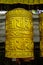 Nepali buddhist golden prayer wheel with letter symbols