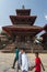 Nepali people pass a Hindu Temple which damaged by earthquake , Kathmandu , Nepal