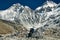 Nepali porter on a trail on a sunny day wanders through the beautiful Himalayan valley.