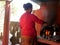 Nepali women use antique vintage retro kitchenware cooking food nepalese style on old stove fireplace at local restaurant for sale