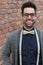 Nerd Guy With Glasses, Bow Tie, and Brick Wall Background