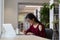 Nerdy Asian girl in glasses working on university research project in library