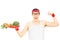 Nerdy guy holding plate with vegetables and showing muscle