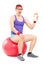 Nerdy guy sitting on fitness ball and holding milk bottle