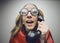 Nerdy woman speaking on a black rotary vintage phone