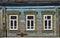 Nerekhta town, Kostroma Oblast, Russia, May 26, 2021:  Carved wooden platbands on windows of old wooden house on Krasnoarmeyskaya