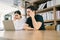 The nervous Asian male and female sitting in front of a laptop, looking with a bad and uncomfortable feeling