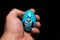 Nervous blue Easter egg in someones hand