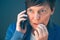 Nervous businesswoman bites fingernails during telephone convers