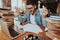 Nervous Guy Sitting at Table With Stacks of Books