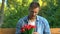 Nervous man with bunch of tulips sitting on bench waiting for girlfriend, date