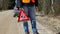 Nervous man with warning triangle on the road near car