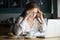 Nervous stressed female student feeling headache studying in caf