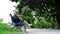 Nervous young woman sits on antique bench with crossed legs