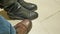 Nervously knocks foot in anticipation of something. men`s shoes and women`s boots close-up shot