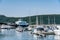 Nesna, Norway - August 06, 2019: View at marina of Nesna: alot of motorboats, sailboats, fisherman boats in calm blue ocean. Trip