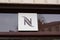 Nespresso brand logo and text sign of shop facade coffee machines capsules and