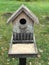 A nest box or bird house decorated with white flowers