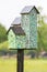 Nest boxes with mosaic tiles on pole