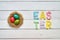 Nest wreath, eggs, easter folded paper origami colorful lettering on white wooden planks rustic background
