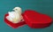 Nestlings little yellow chick in a red gift box in heart shape