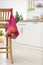 Net bag with vegetables hanging on chair in kitchen