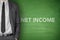 Net income text on green blackboard
