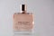 NETANYA,ISRAEL- July 07, 2020:Closeup of Givenchy irresistible perfume in pink miniature bottle on pink background