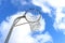 Netball goal ring and net against a blue sky and clouds