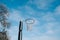 Netball goal ring and net against a blue sky and clouds at Hagley park, Christchurch, New zealand