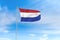 Netherlands flag over blue sky background