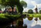 Netherlands landscape with pond and windmill. Generative AI Art. Beautiful view