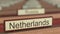Netherlands name sign among different countries plaques at international organization. 3D rendering
