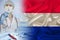 Netherlands national flag on satin, doctor with syringe, country population vaccination concept, medical development, covid-19