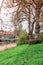 The netherlands a typical dutch city view from the park with water, road and grass at sundown