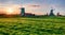 Netherlands windmills at sunset on green field