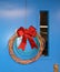 Network Cabling Christmas wreath with glittery bow hung on blue door