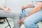 The neurologist testing knee reflex on a female patient using a hammer. Neurological physical examination. Selective focus, close