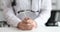 Neurologist in white coat holds metal hammer closeup