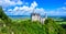 Neuschwanstein Castle in beautiful mountain scenery of Alps- in the background you can see the Lake Forggensee - near Fuessen,