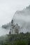 Neuschwanstein Castle with mystery and foggy environment, famous place and travel destination in Fussen, Germany