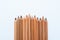 Neutral color skin pencils aligned on a white canvas