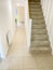 Neutral colour home interior floor tiles and staircase