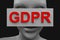 Neutral face of a woman is closed with the inscription GDPR