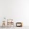 Neutral interior mockup with wooden chair, teable with fan in empty wall background.