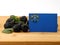 Nevada flag on a wooden panel with blackberries isolated on a wh