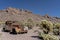 In Nevada, an old vintage car sits in the desert landscape.